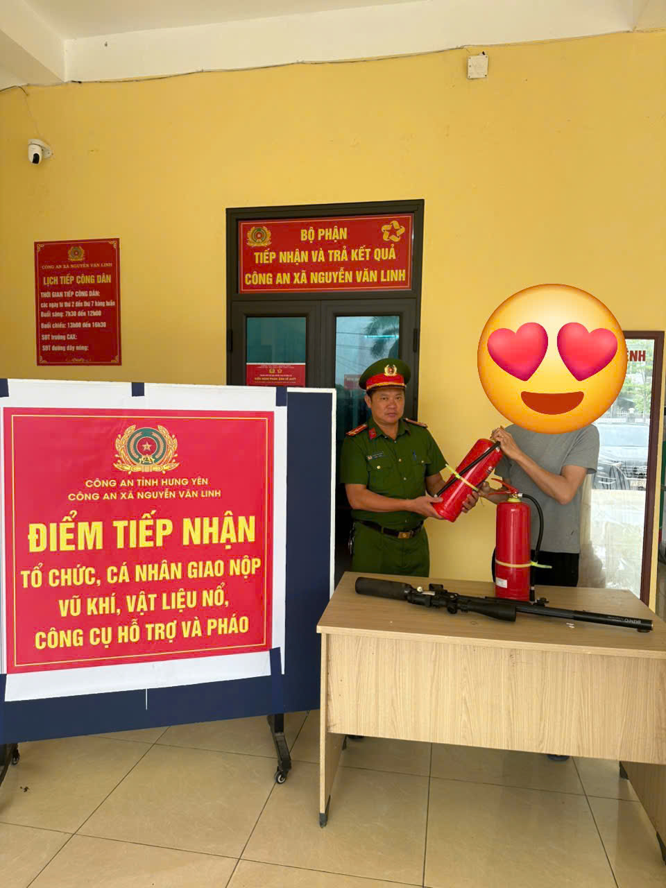 Công dân L.V.D nhận bình chữa cháy khi giao nộp vũ khí.jpg
