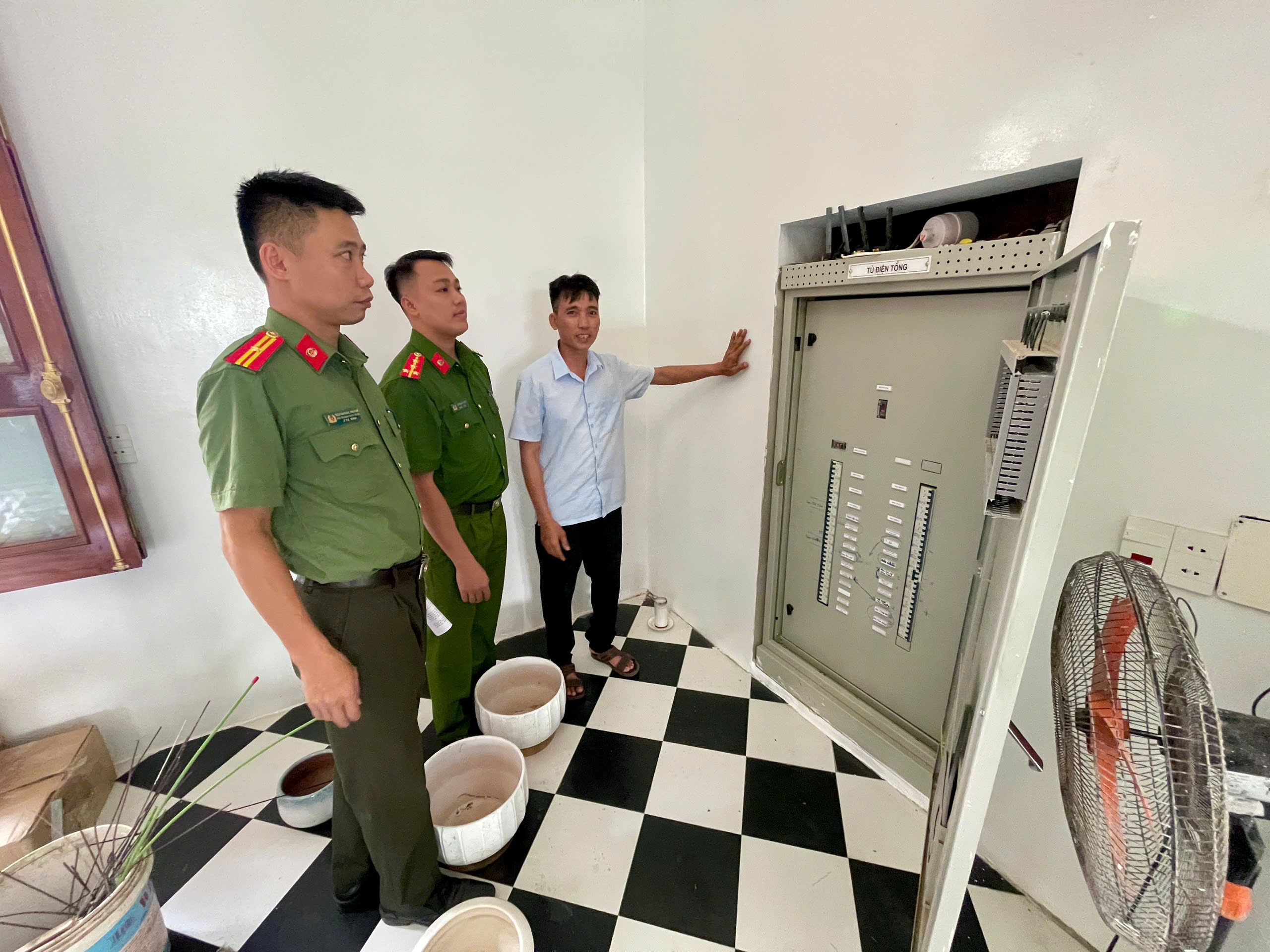 Công an xã kiểm tra hệ thống tủ điện tổng, thiết bị điện phục vụ lễ.